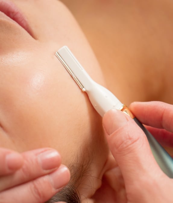 closeup of woman's face undergoing dermaplaning skin rejuvenation treatment