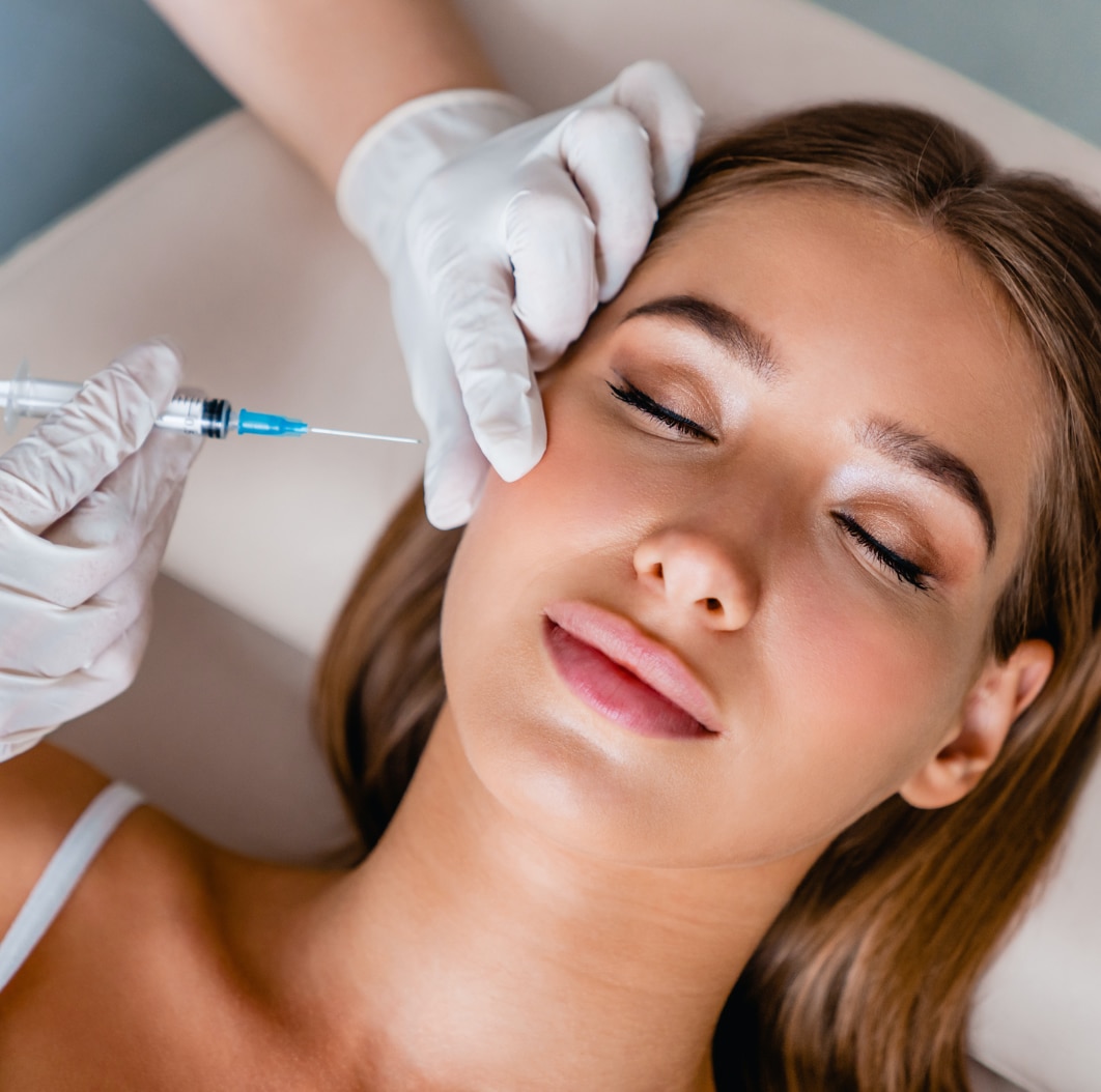 Woman laying down eyes close, smiling, receiving facial shot