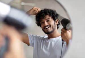 Excited,Indian,Man,Using,Hairdryer,After,Shower,,Drying,His,Curly