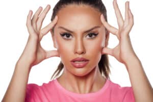Woman holding her face wanting natural facelift in Salt Lake City, UT