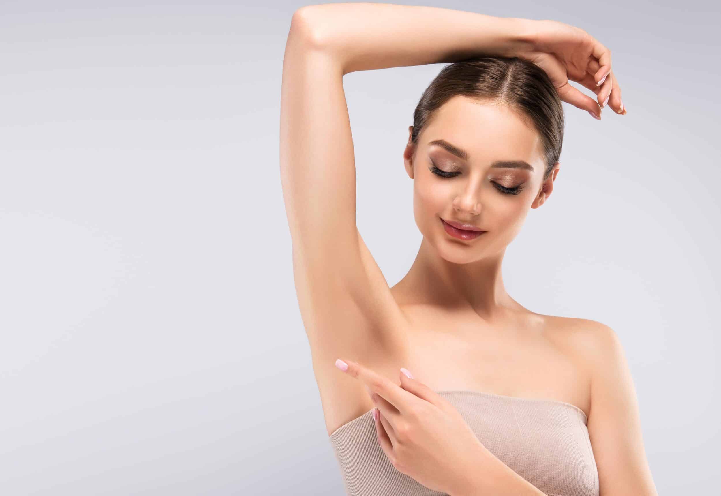 Woman looking at her smooth underarm after laser hair removal in Salt Lake City, UT
