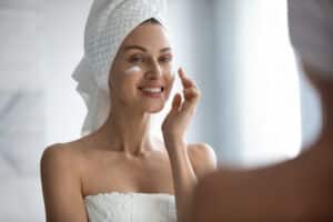 Woman smiling with moisturizer after a laser peel in Salt Lake City, UT