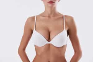 Close up of woman's breasts in a bra after breast augmentation
