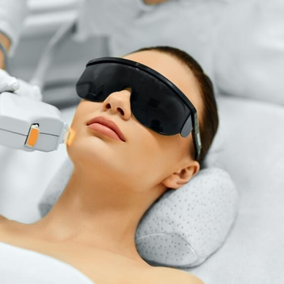 woman tanning in the sun with glasses